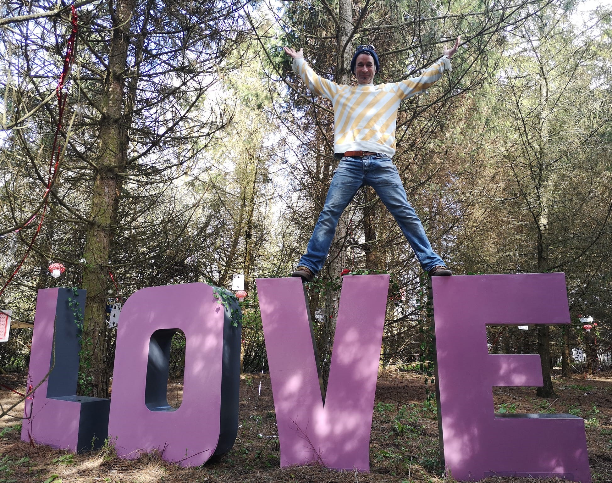 Big Love sign with Person On Top